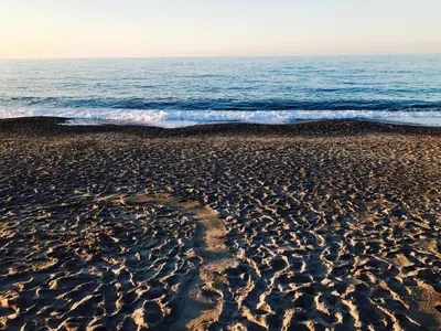 a sandy beach with the ocean in the background at Katerina Seaside Studios in Plataniás