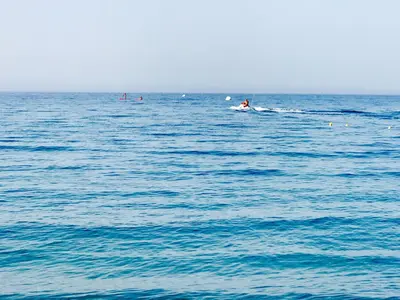 a group of people in the water in the ocean at Katerina Seaside Studios in Plataniás