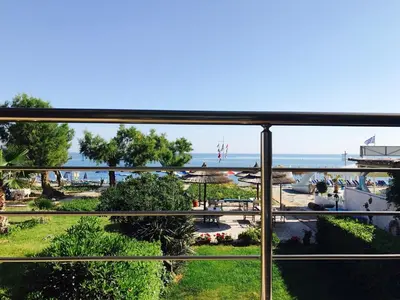 a view of the beach from the balcony of a resort at Katerina Seaside Studios in Plataniás