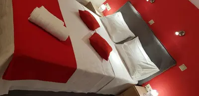 a room with a bed with red and white pillows at Rodoula Luxury Apartment 1 in Chania Town