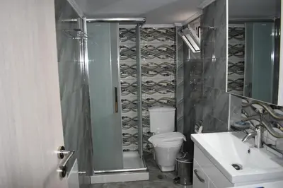 a bathroom with a toilet and a shower and a sink at Rodoula Luxury Apartment 1 in Chania Town
