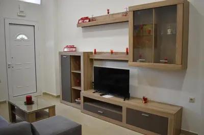 a living room with a flat screen tv on a entertainment center at Rodoula Luxury Apartment 1 in Chania Town