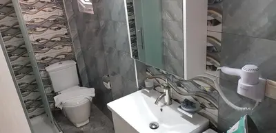 a bathroom with a sink and a toilet and a mirror at Rodoula Luxury Apartment 1 in Chania Town