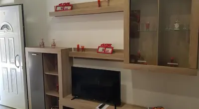 a living room with a tv and wooden shelves at Rodoula Luxury Apartment 1 in Chania Town