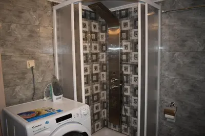 a washing machine in a bathroom with a shower at Rodoula Luxury Αpartment 2 in Chania Town