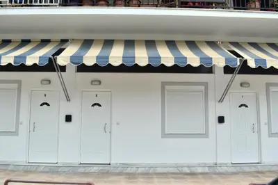 a row of white doors on a building at Rodoula Luxury Αpartment 2 in Chania Town