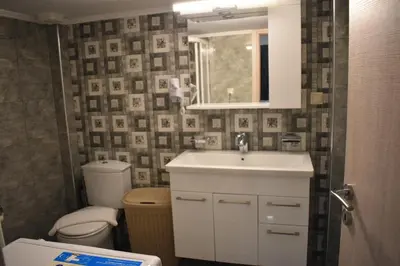 a bathroom with a sink and a toilet and a mirror at Rodoula Luxury Αpartment 2 in Chania Town