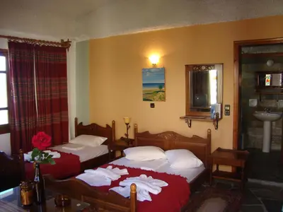 a bedroom with two beds with towels on them at Drapanias BeachFront Apartments - Marinakis in Kissamos