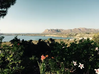 a view of a lake with mountains in the background at Theodosia Studios in Kalathas