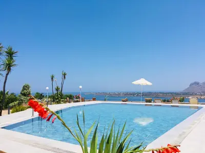 a swimming pool with a view of the ocean at Theodosia Studios in Kalathas