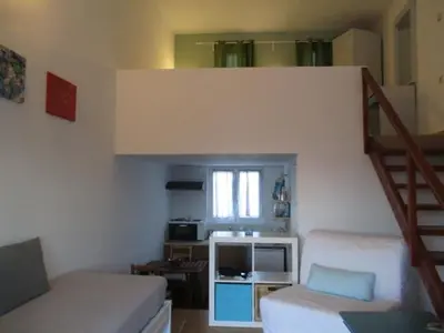 a small living room with a staircase and a couch at Theodosia Studios in Kalathas