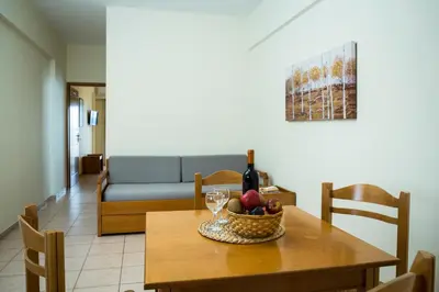 a table with a bowl of fruit and a bottle of wine at Gramvoussa Bay in Kissamos