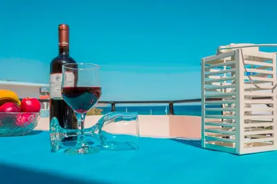a bottle of wine and a glass on a table at Oreia in Palaiochóra