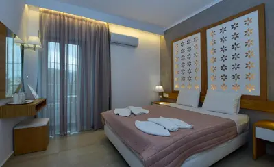 a bedroom with a bed with two towels on it at Hotel Aghas Paleochora in Palaiochóra