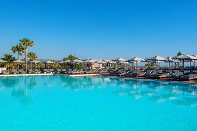 a large swimming pool with chairs and umbrellas at Solimar Aquamarine Resort in Gerani Chanion