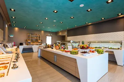 a cafeteria with a buffet line with food at Solimar Aquamarine Resort in Gerani Chanion