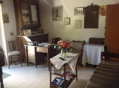 a living room with a vase of flowers on a table at Oasis Guesthouse in Chania Town