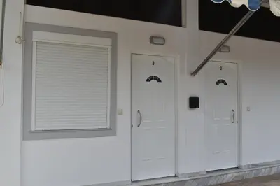 a room with three white doors and a window at Rodoula Luxury Αpartment 3 in Chania Town