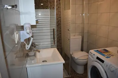 a bathroom with a sink and a washing machine at Rodoula Luxury Αpartment 4 in Chania Town