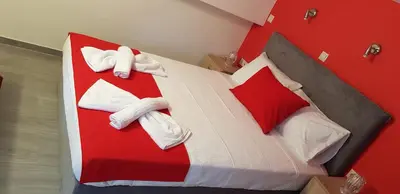a red and white bed in a room at Rodoula Luxury Αpartment 4 in Chania Town