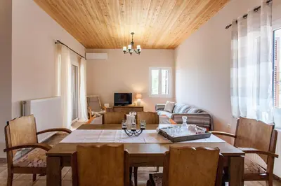 a living room with a table and a couch at Villa Vendema in Arménoi