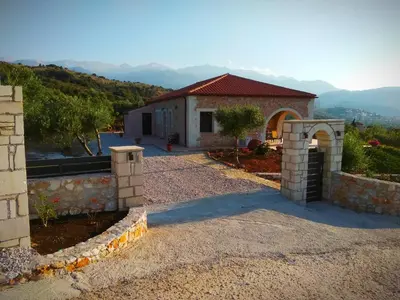 a house with a gate in front of a yard at Villa Vendema in Arménoi
