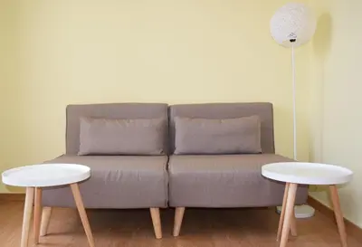 a couch with two tables in a living room at Central House with Quiet Garden in Kissamos