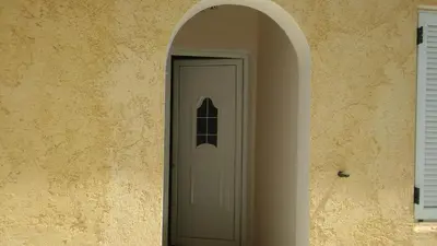 an archway leading to a white door in a building at Sitzanaki Home in Chania Town