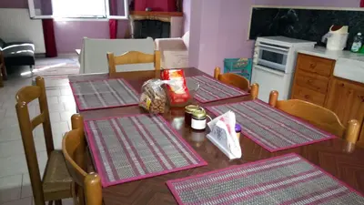 a kitchen with two tables with purple mats on them at Sitzanaki Home in Chania Town