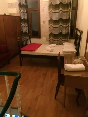 a room with a table and a couch and a table and chair at Rooms 47 in Chania Town