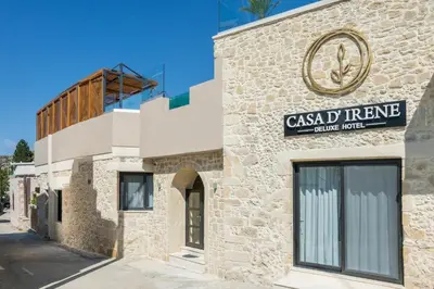 a building with a sign on the side of it at Casa D'Irene Deluxe Hotel in Falasarna