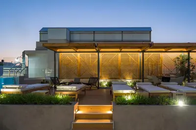 a patio with tables and chairs on a building at Casa D'Irene Deluxe Hotel in Falasarna