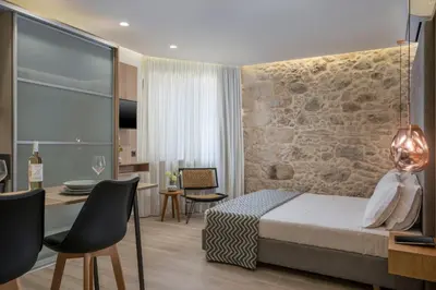 a hotel room with a bed and a table and chairs at Casa D'Irene Deluxe Hotel in Falasarna