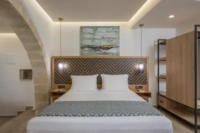 a bedroom with a large bed in a room at Casa D'Irene Deluxe Hotel in Falasarna