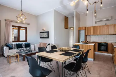 a kitchen and living room with a table and chairs at Lila hill house in Stalos
