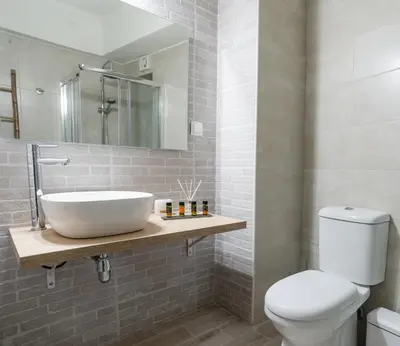 a bathroom with a sink and a toilet at Aelia Apartments in Chania Town