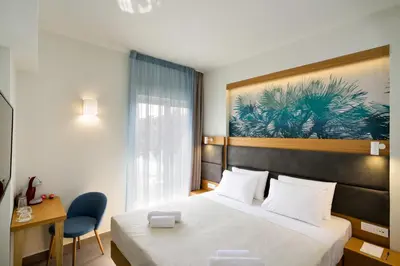a hotel room with a bed and a desk at Elia Kalamaki Hotel in Kalamaki Chanion
