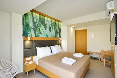 a hotel room with a bed with two towels on it at Elia Kalamaki Hotel in Kalamaki Chanion