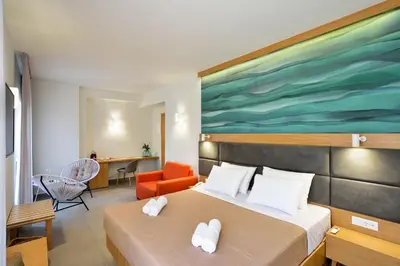 a hotel room with a bed and a painting on the wall at Elia Kalamaki Hotel in Kalamaki Chanion