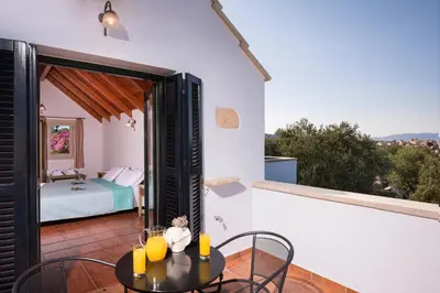 a room with a table and chairs and a bedroom at Orionas Village in Kato Daratso