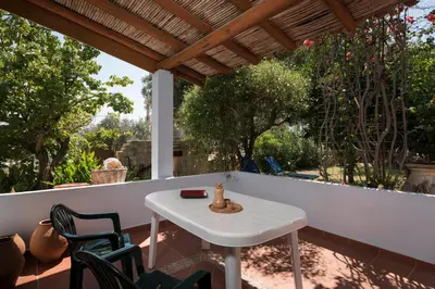 a white table and chairs on a patio at Orionas Village in Kato Daratso