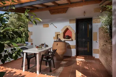 a patio with a table and chairs and a door at Orionas Village in Kato Daratso