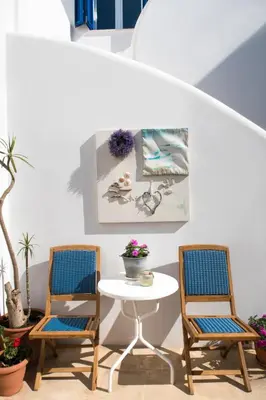 two chairs and a table in a room with a table at Astra Hotel Apartments in Kato Daratso