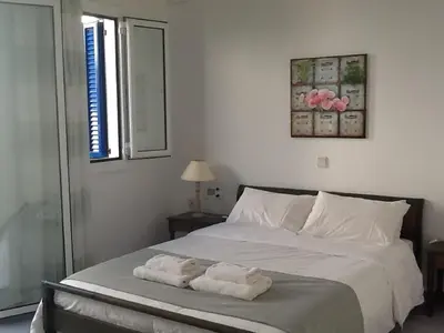 a bedroom with a bed with two towels on it at Astra Hotel Apartments in Kato Daratso