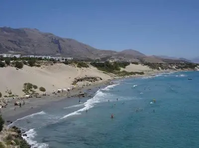 a group of people swimming in the ocean on a beach at Fragokastello Star in Frangokastello