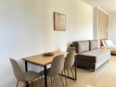 a living room with a table and chairs and a couch at Pachia Ammos Falasarna in Falasarna