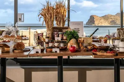 a table with food on it with a view of the ocean at Evexia Boutique Hotel & Spa in Agia Marina Nea Kydonias