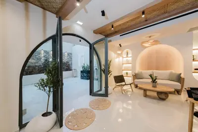 a living room with a couch and a table at Evexia Boutique Hotel & Spa in Agia Marina Nea Kydonias