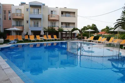 a large swimming pool in front of a hotel at Melina Beach in Plataniás