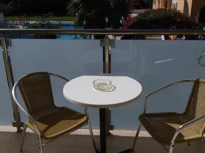 a table and two chairs and a white table and chairs at Angelica Studios and Apartments in Agia Marina Nea Kydonias